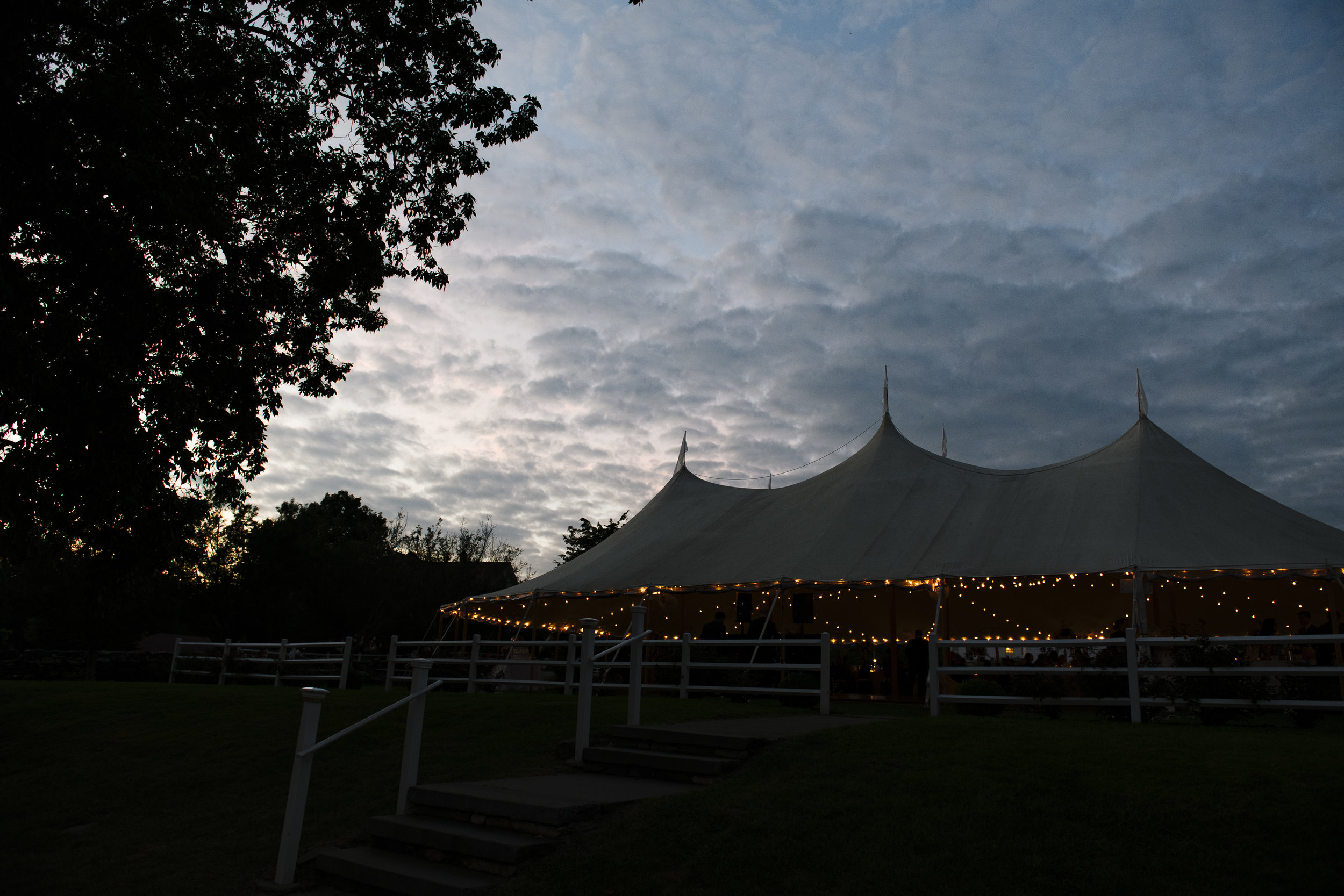 Beautiful skies with a sperry tent outside for a Jonathan Edwards Winery wedding in Connecticut - Pearl Weddings &amp; Events