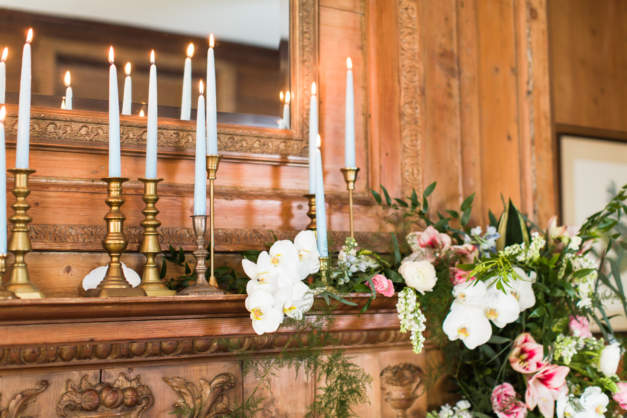 Candle lite mantel with white orchids, greenery and pink flowers at the Haley Mansion in Mystic Connecticut - Pearl Weddings &amp; Events