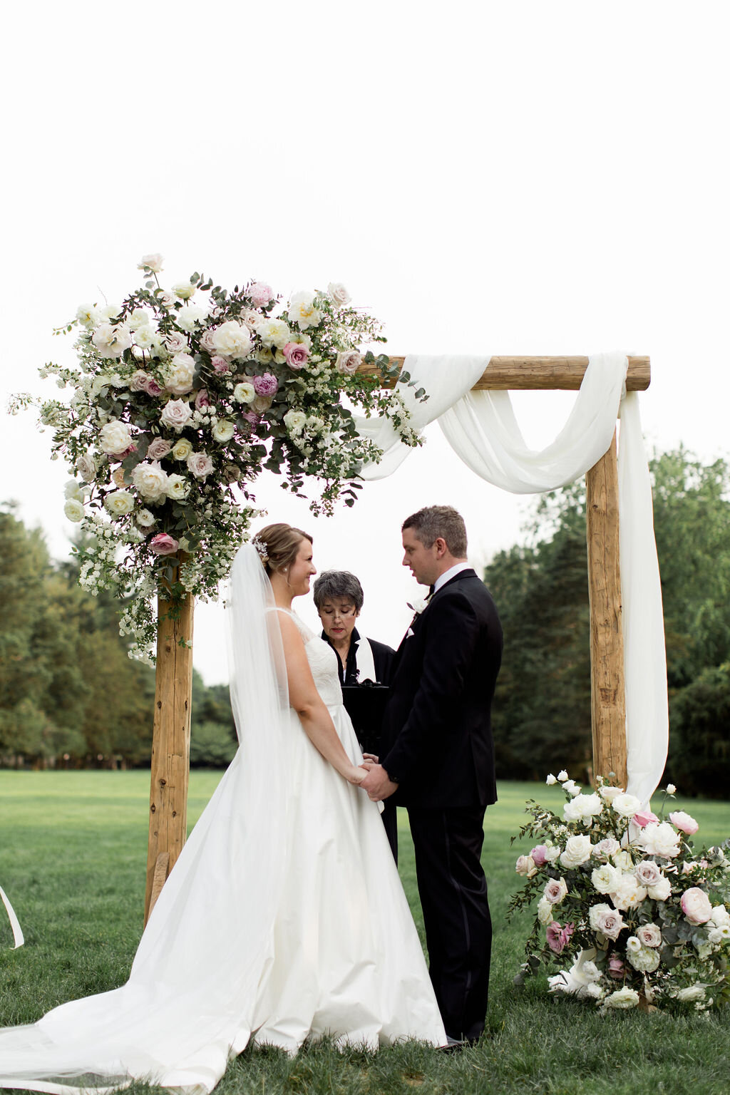 White and blush pink ceremony arch florals with fabric drapery - Pearl Weddings &amp; Events