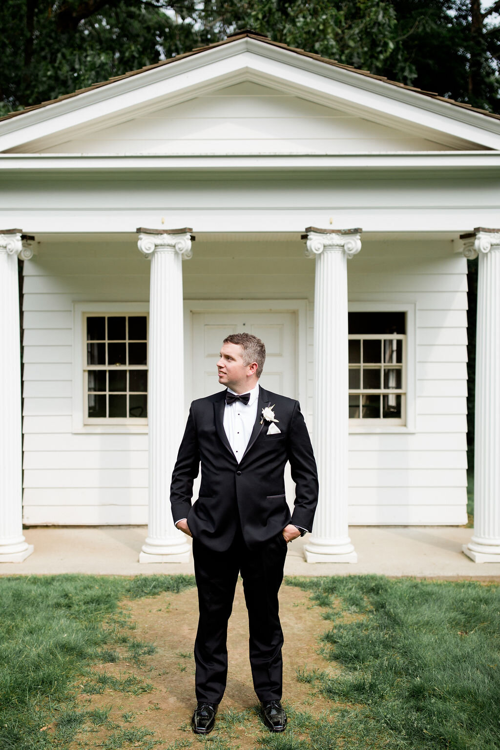 Groom with Black Bow Tie and white floral boutonnière - Pearl Weddings &amp; Events