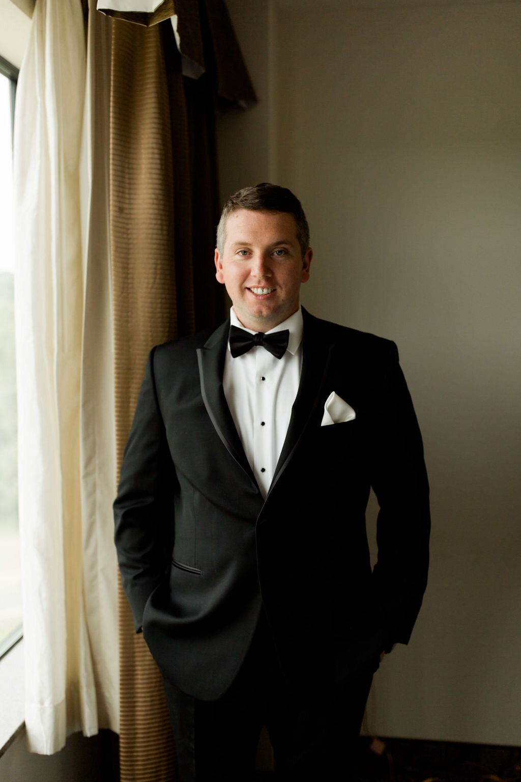 Groom with black bow tie, black jacket and white pocket square - Pearl Weddings and Events