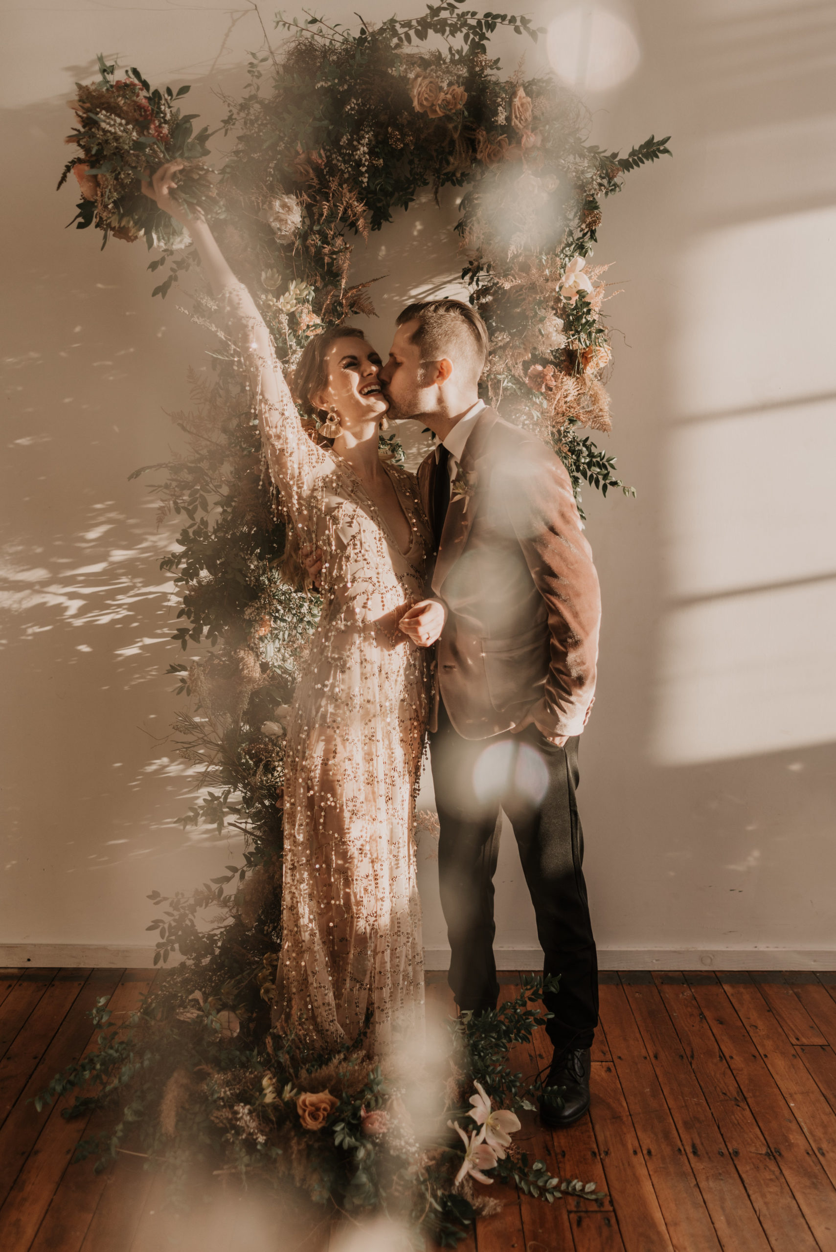 Bride and Grooms first kiss at their Mid-Century Modern Boho wedding - Pearl Weddings &amp; Events