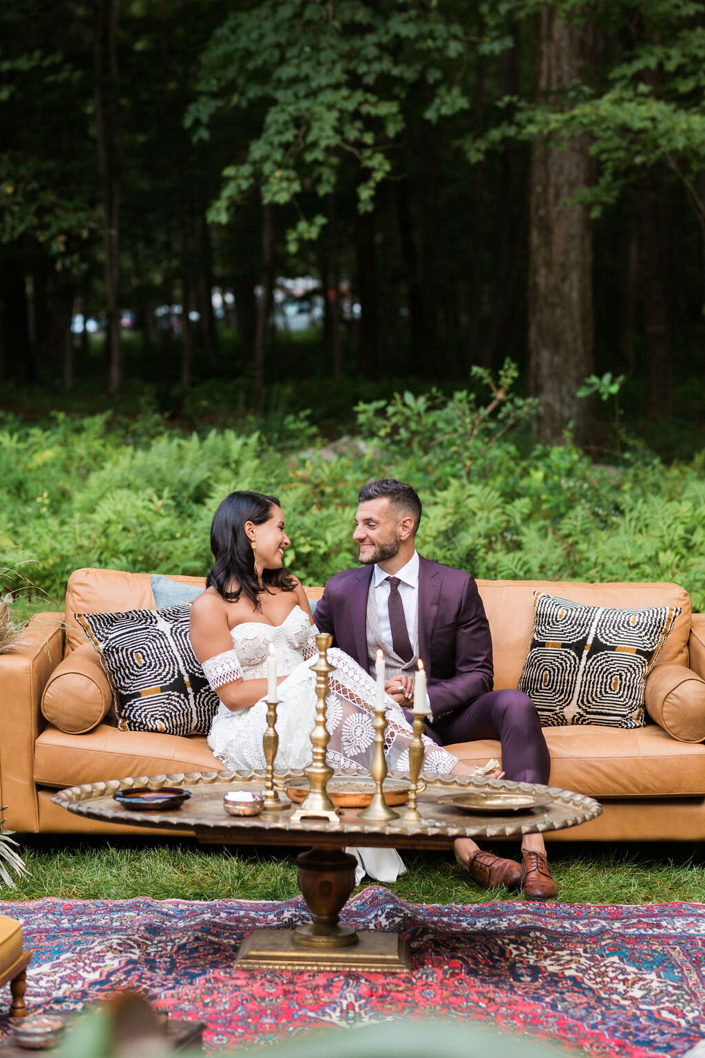 Boho couple with a leather couch in their cigar lounge -Pearl Weddings &amp; Events