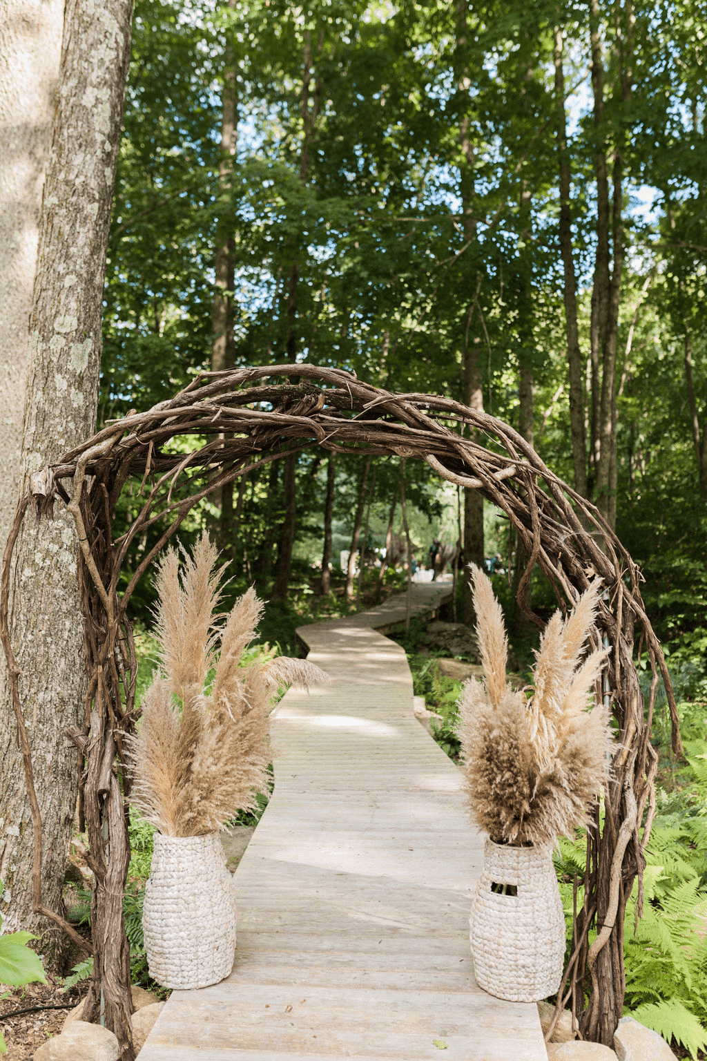 An outdoor walkway with wooden arch