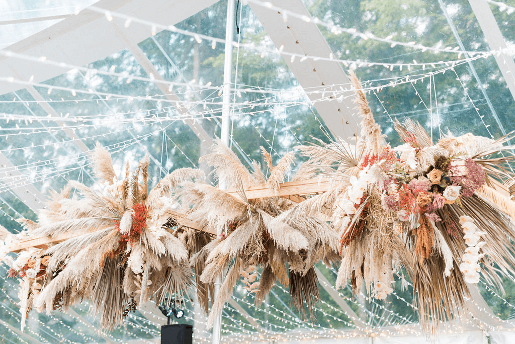 Fairy lights and various flora strung up in the wedding tent