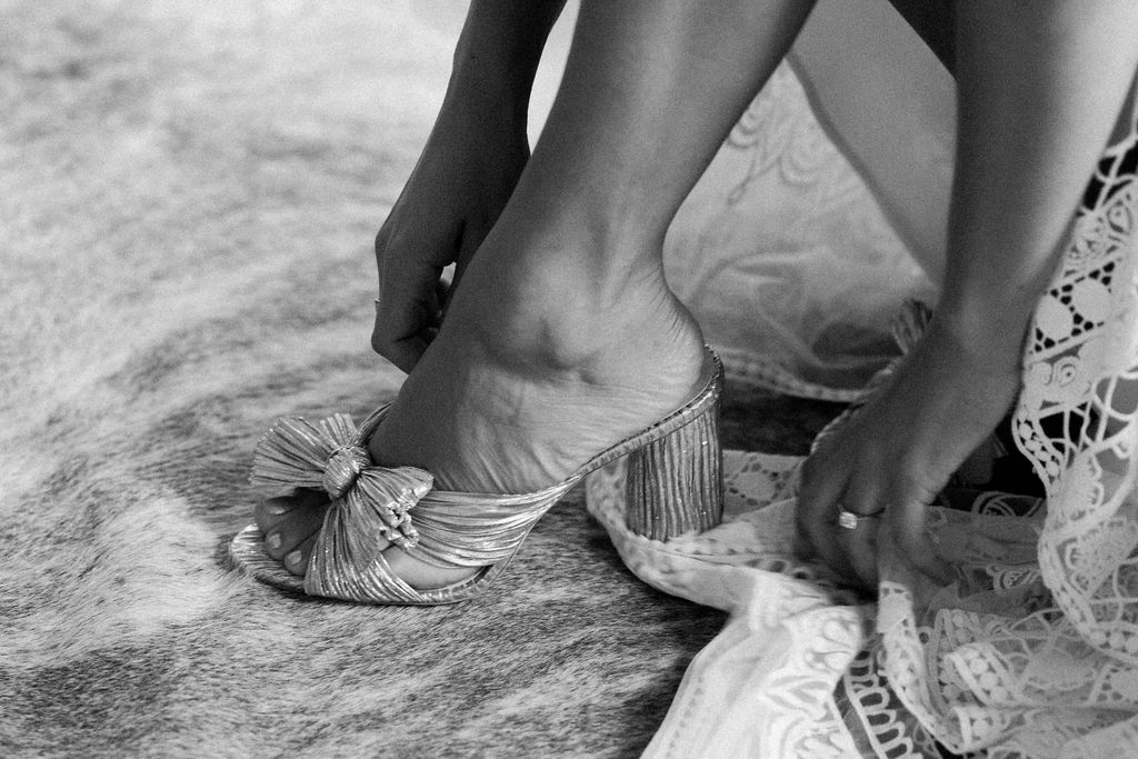 A bride putting on shoes