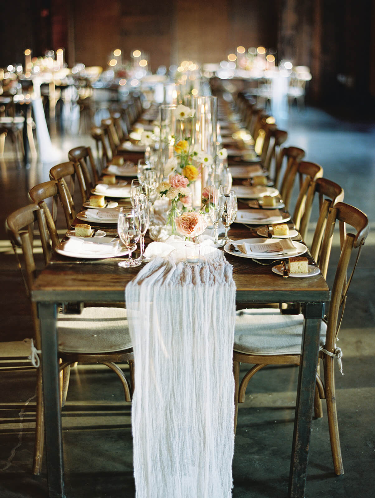 A long table with a linen and flowers