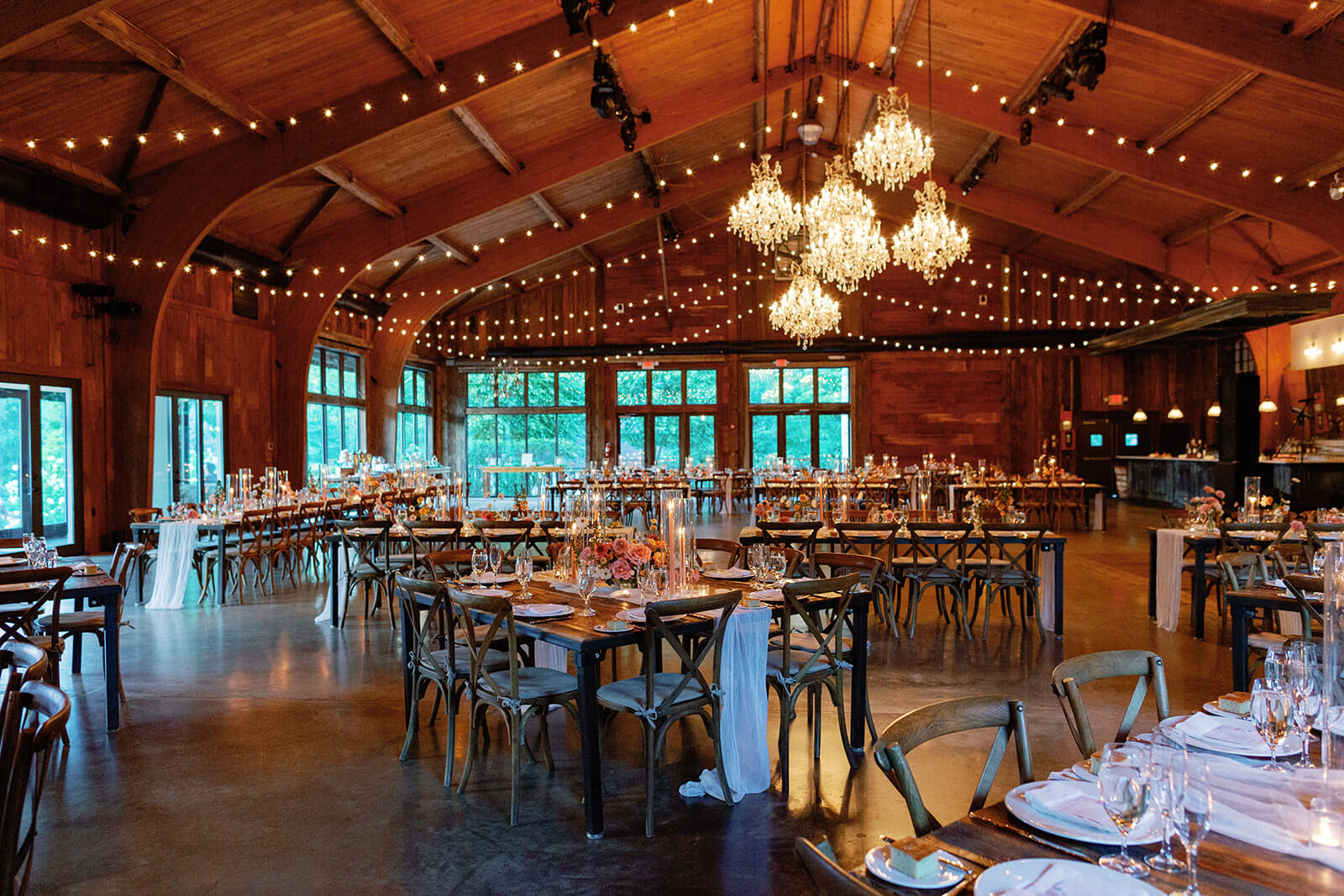 The reception area was held in a rustic barn-like venue where fairy lights were hung among the chandeliers