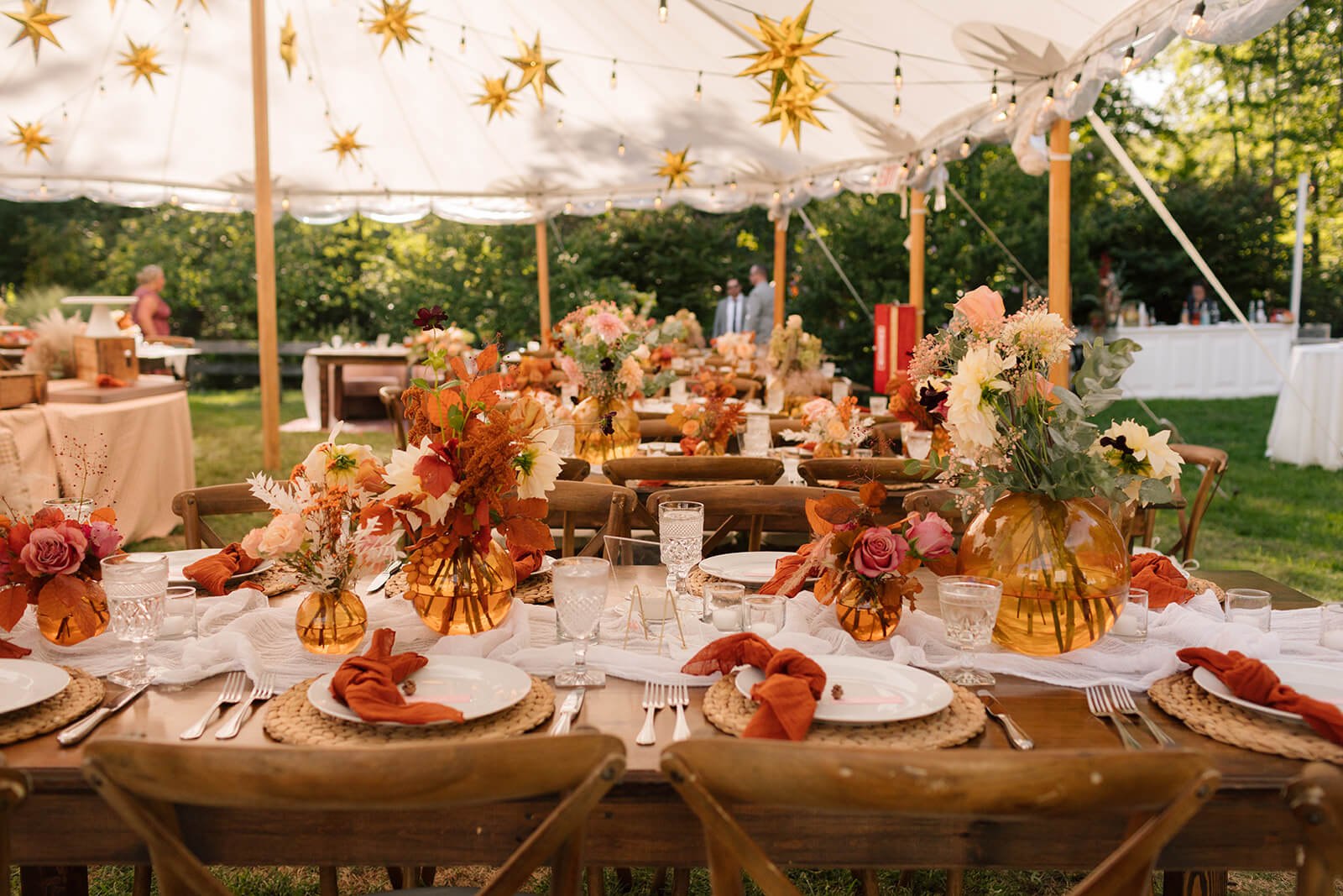 Warmed toned color palette for this tented wedding table setting