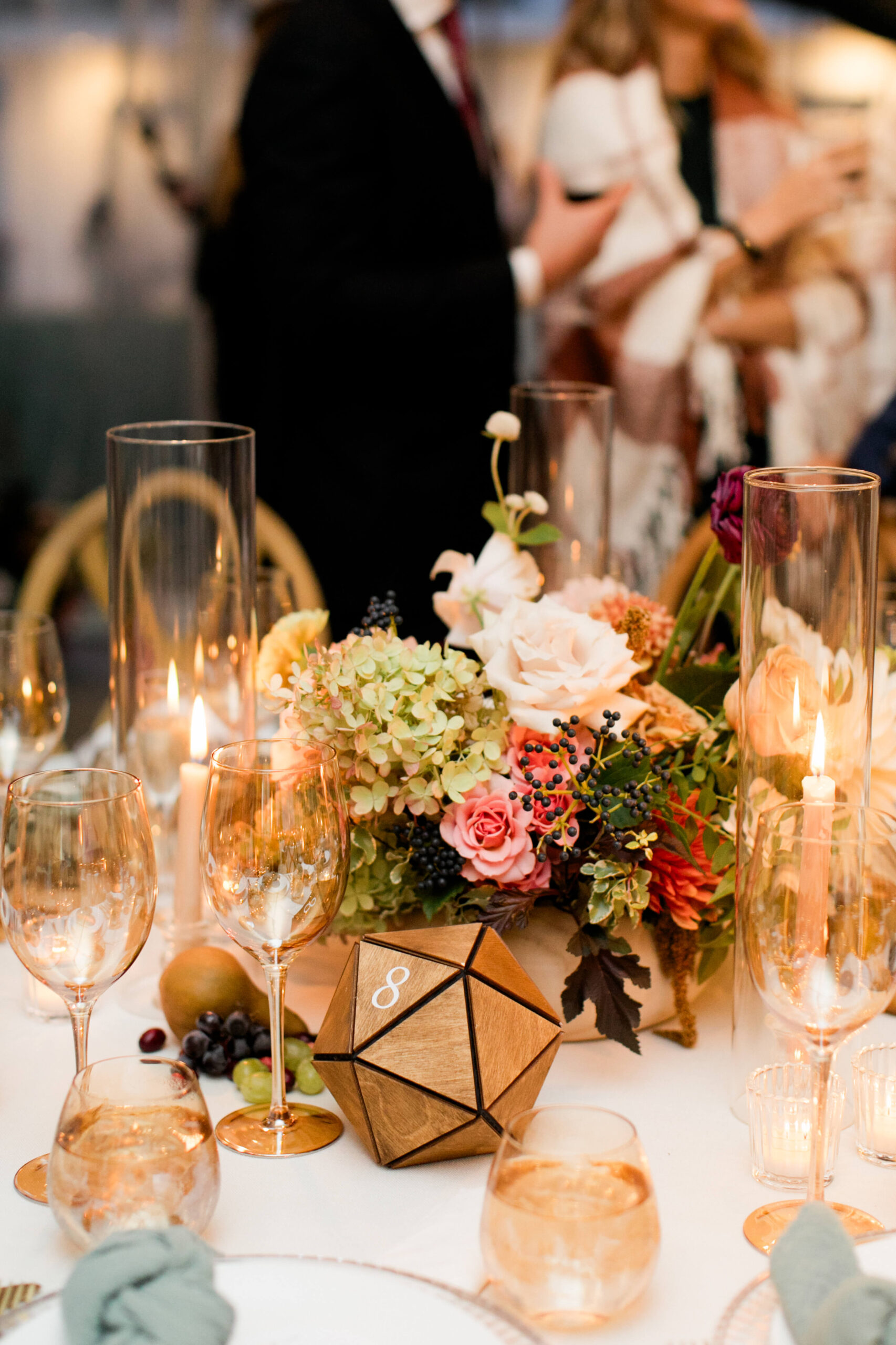 Wedding table with warm toned florals and candles